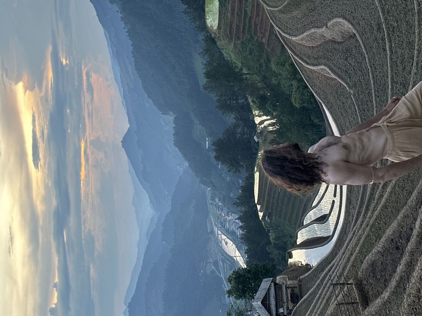 Sapa Muong Hoa Valley rice terraces — lone traveler on ridge above the vast tiered rice terrace landscape