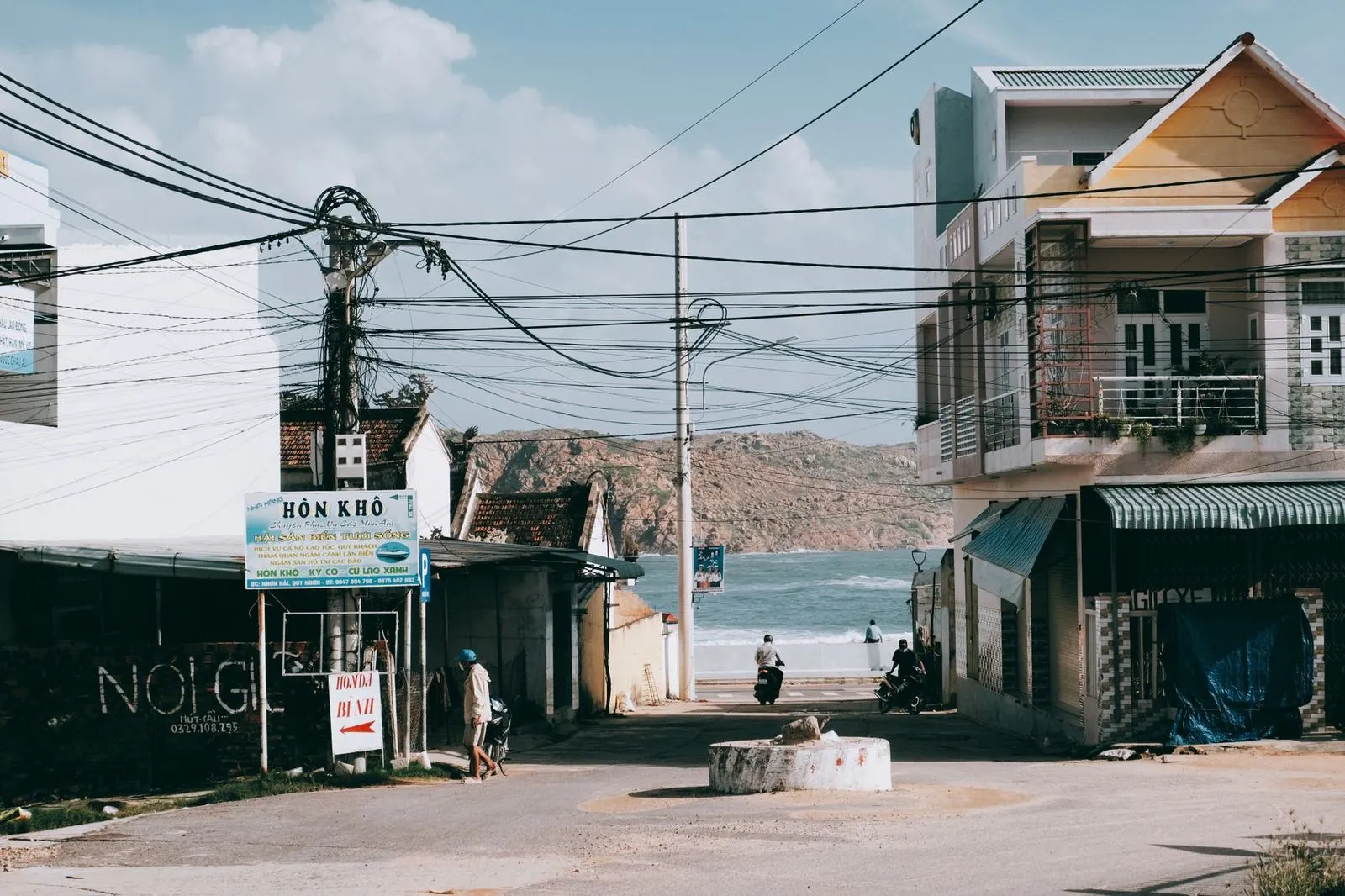 Quiet street in downtown Quy Nhon with a coastal backdrop