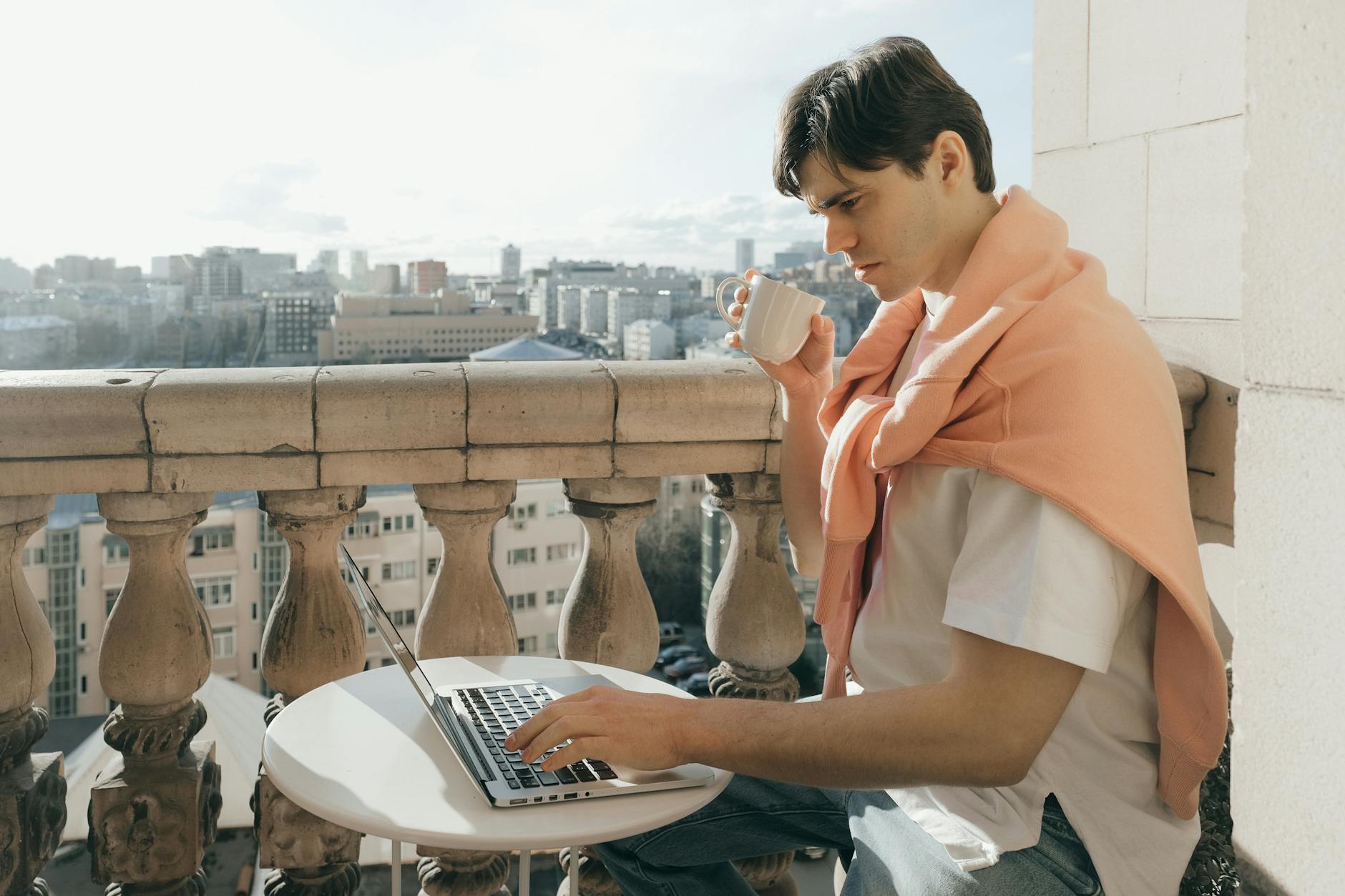 Remote worker with a laptop on a tropical balcony in Vietnam