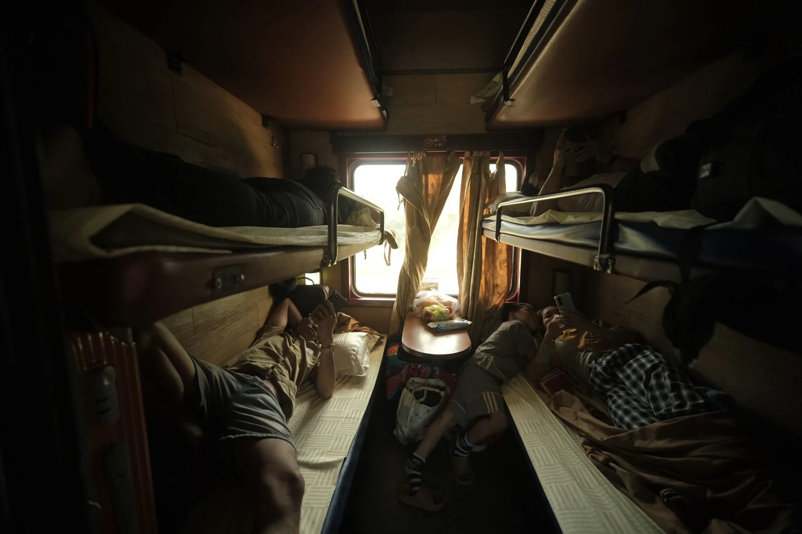 Two lower and two upper bunks inside a 4-berth soft sleeper train compartment