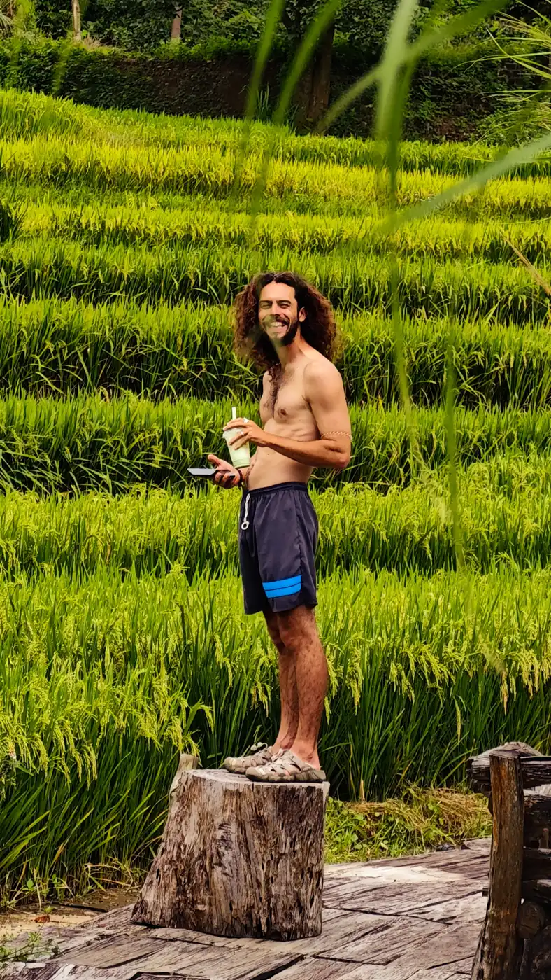 Traveler standing on a tree stump by the Moc Chau rice terraces