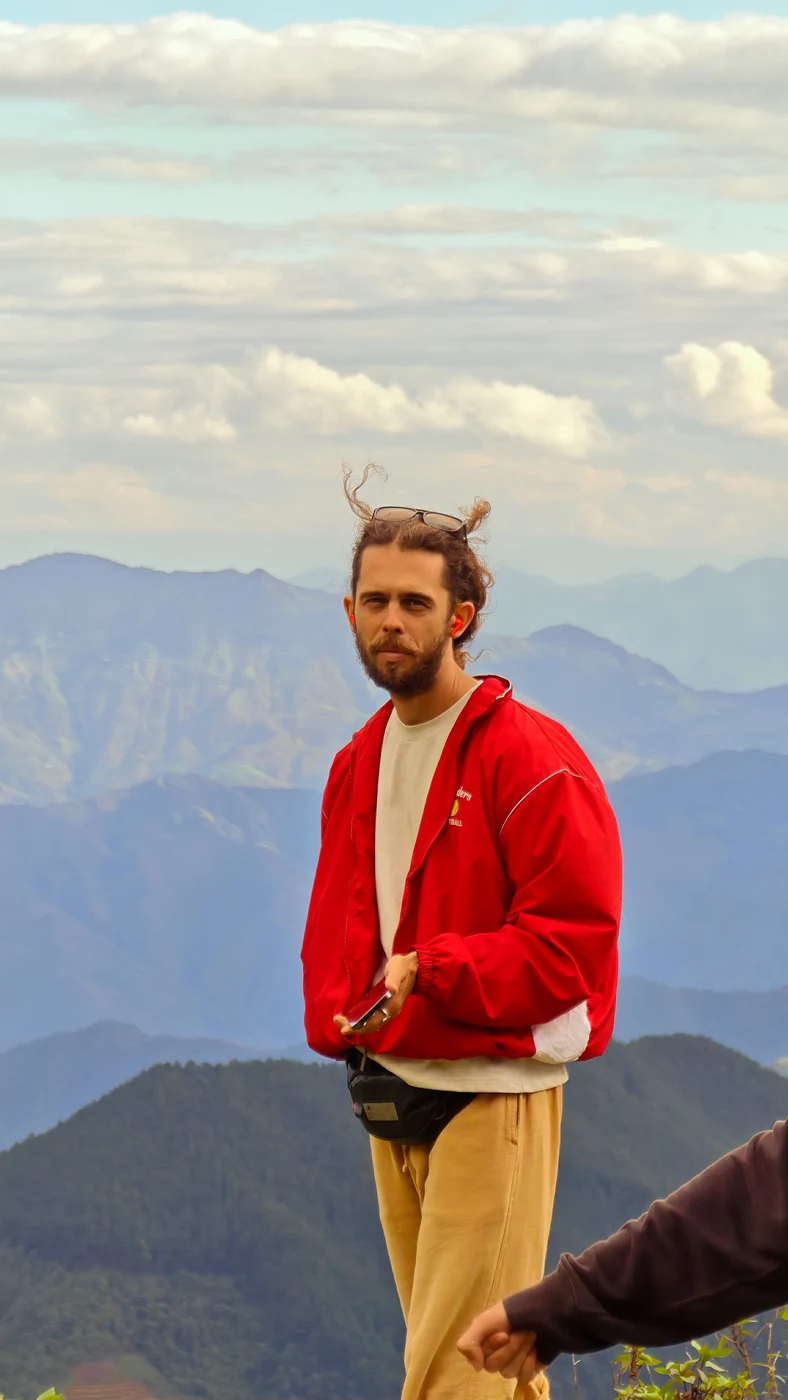 Traveler in a red jacket at a Moc Chau mountain viewpoint