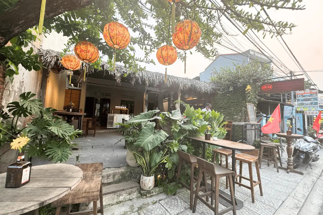 Red lanterns hanging over an open-air cafe in Hoi An