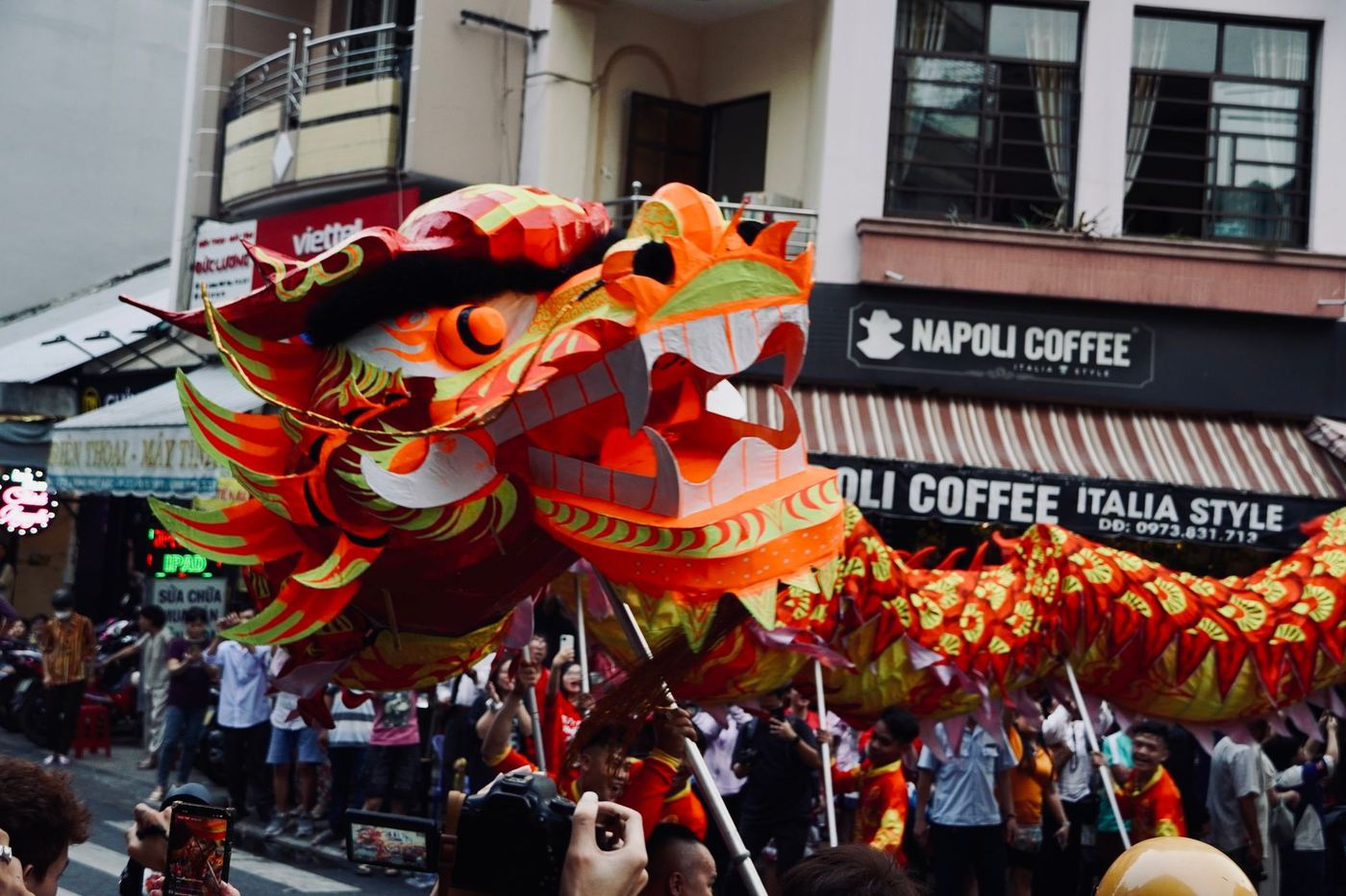 Vietnamese traditional festival with performers in colorful costumes on a decorated street