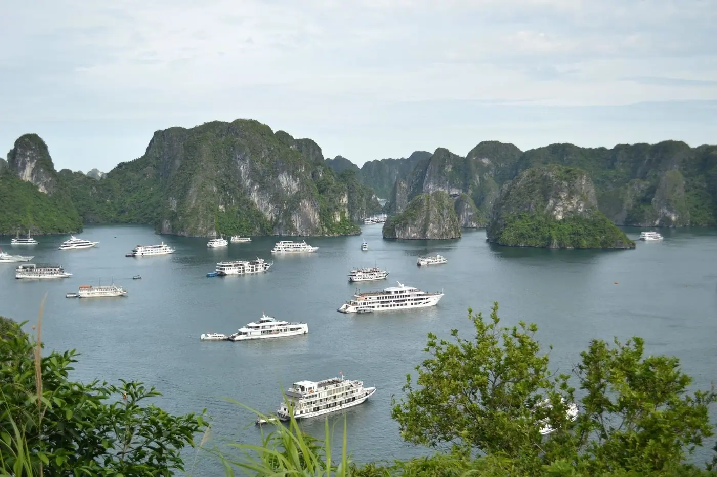 Limestone karst islands with cruise boats anchored in Ha Long Bay
