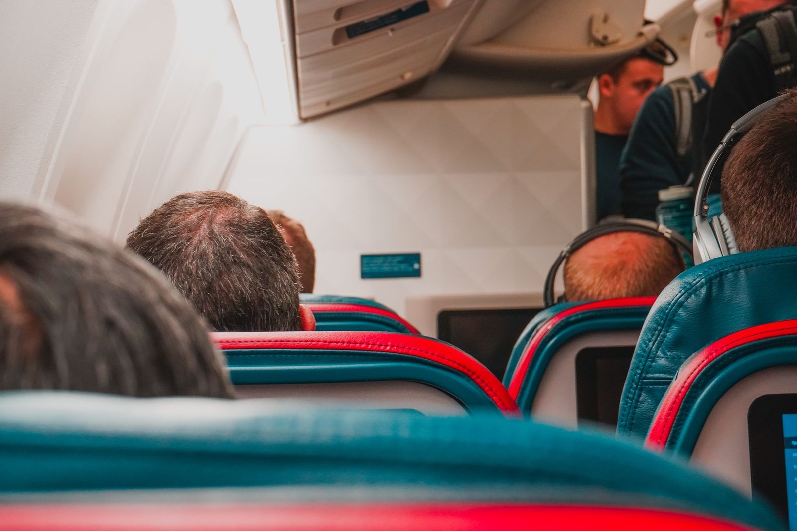 Passengers seated in an airplane cabin during a domestic flight