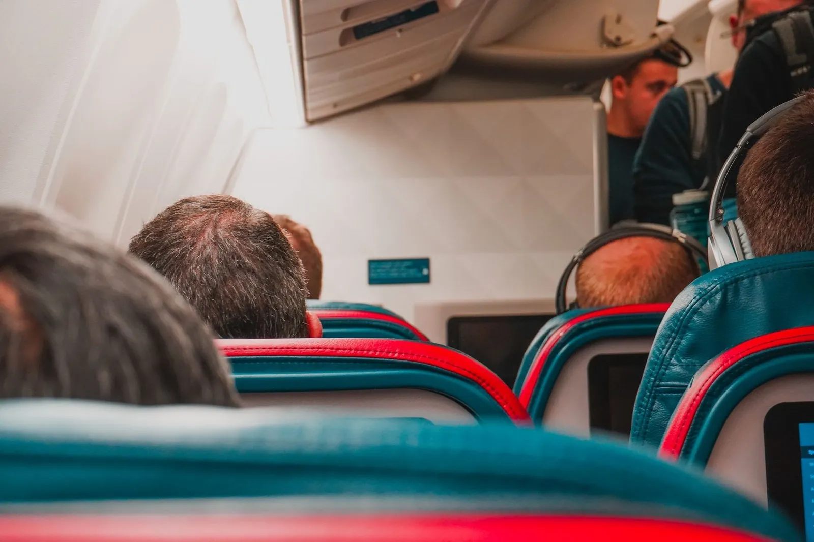 Passengers seated in an airplane cabin during a domestic flight