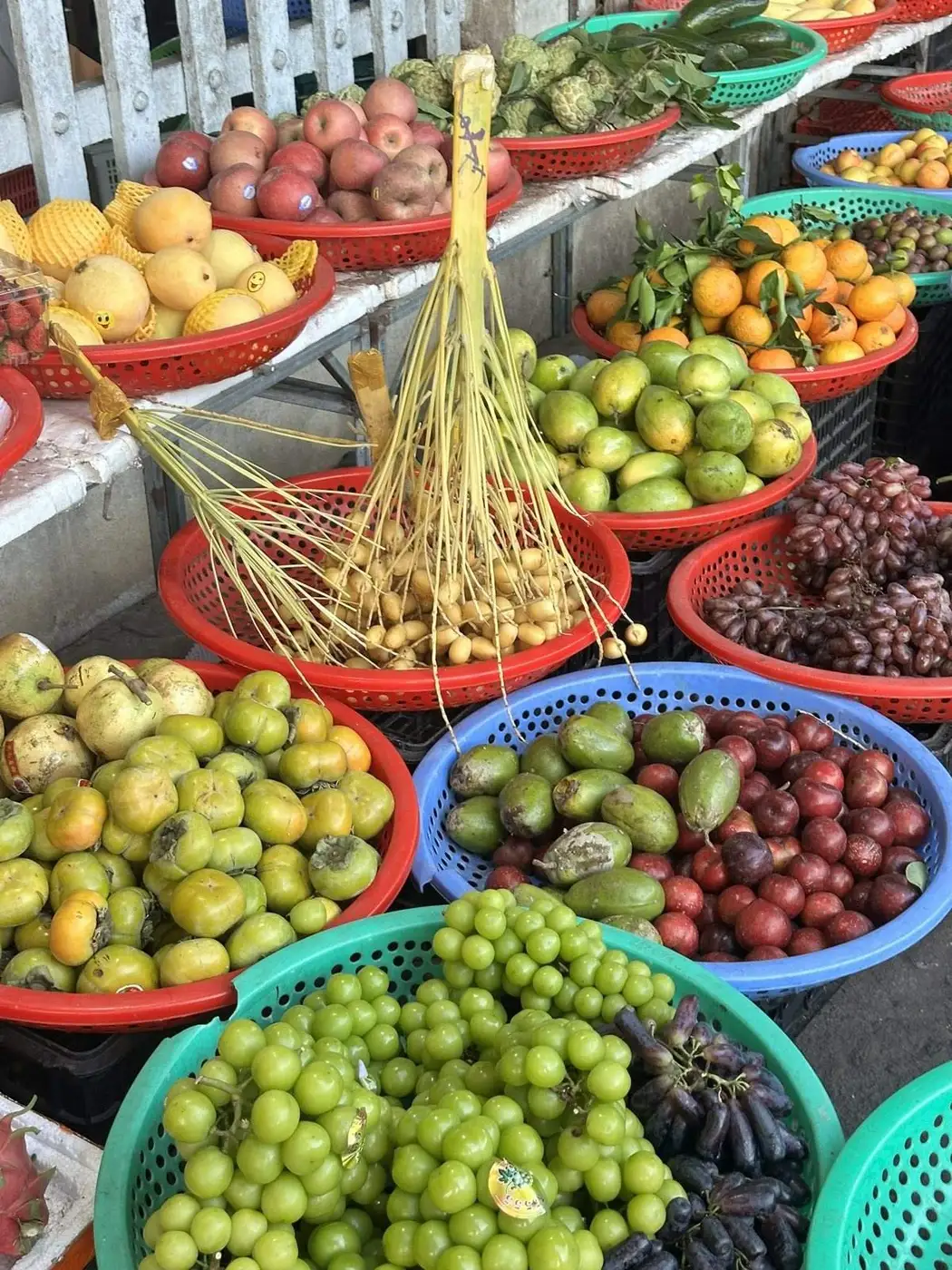 Baskets of fruit on a local market stall in Hoi An