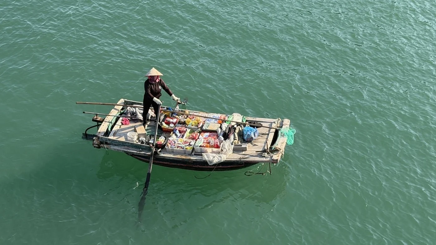 Aerial view of a floating vendor boat in Ha Long Bay