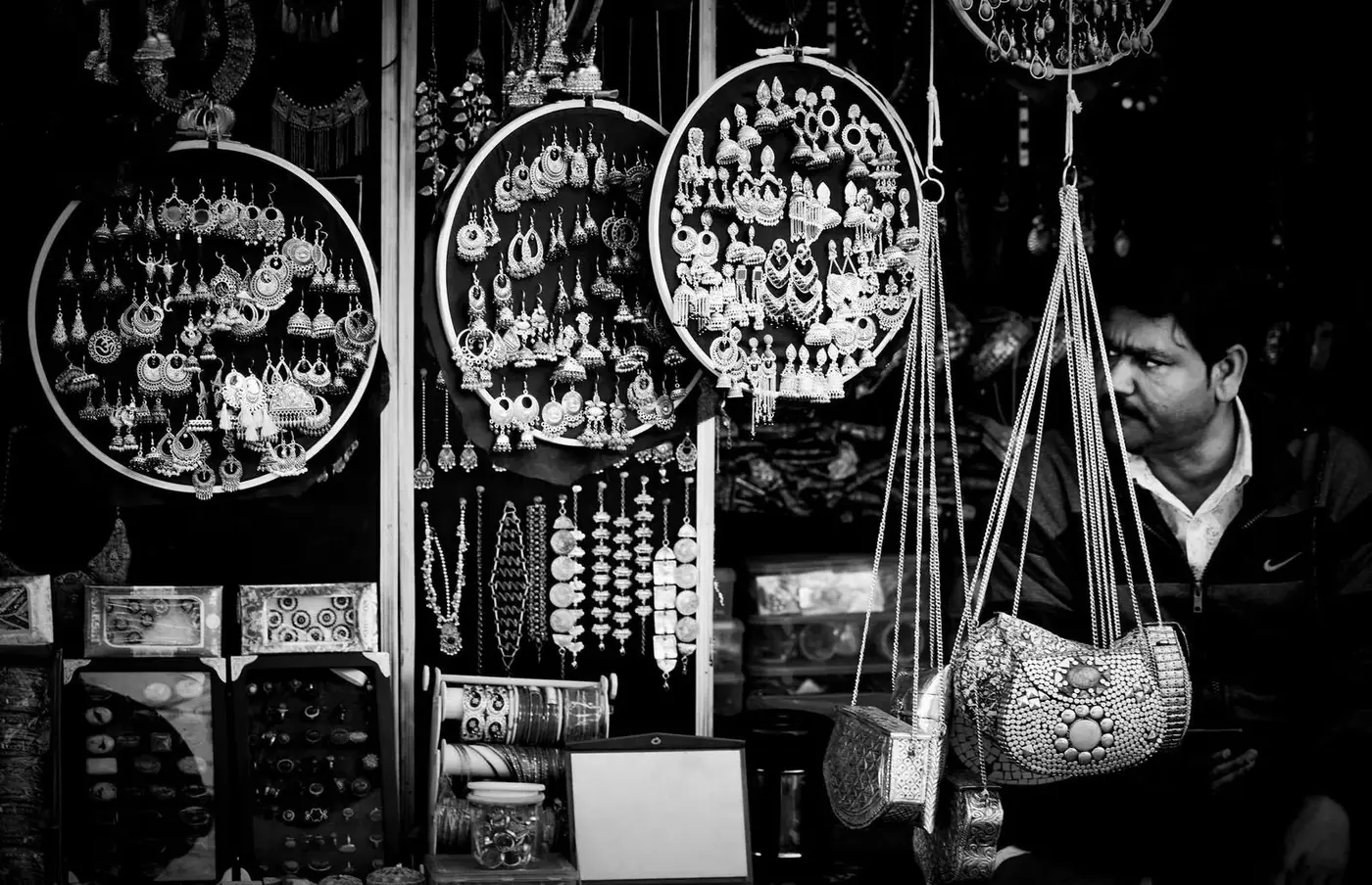 Silver jewelry and earrings displayed for sale at a market stall