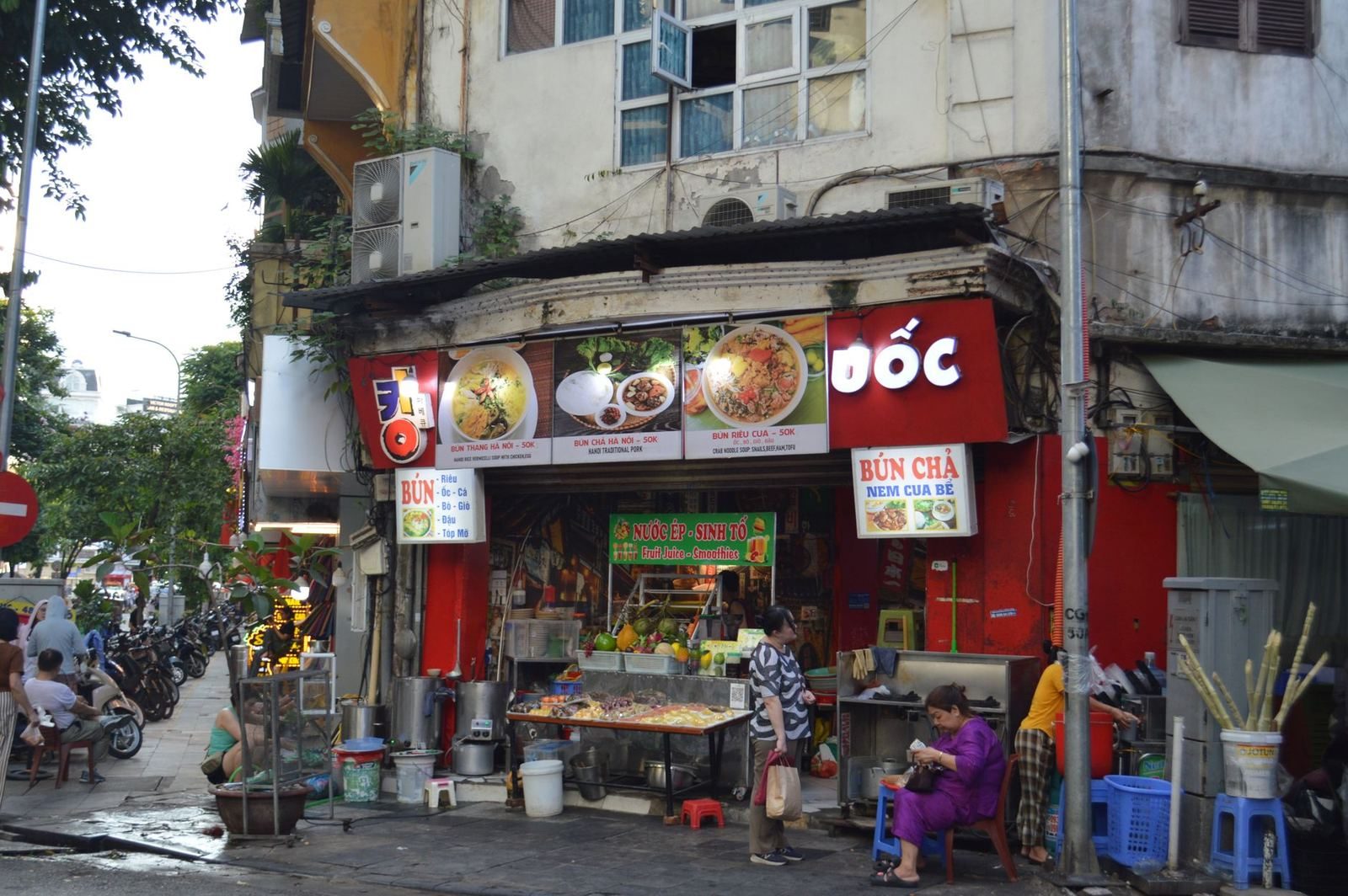 Vietnamese street food stall in Hanoi advertising bun cha and bun rieu