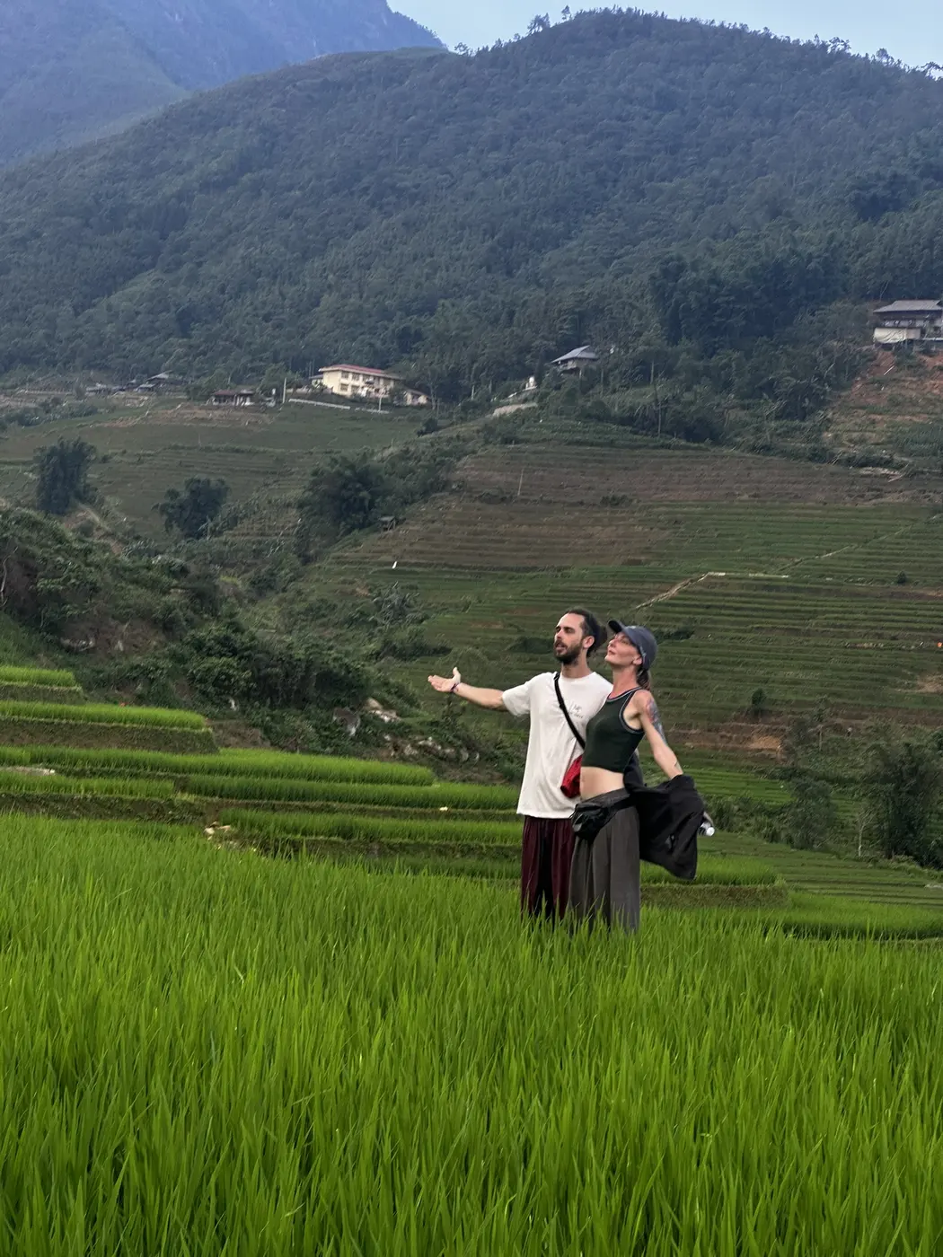 Couple standing in green rice terraces near Sapa, Vietnam