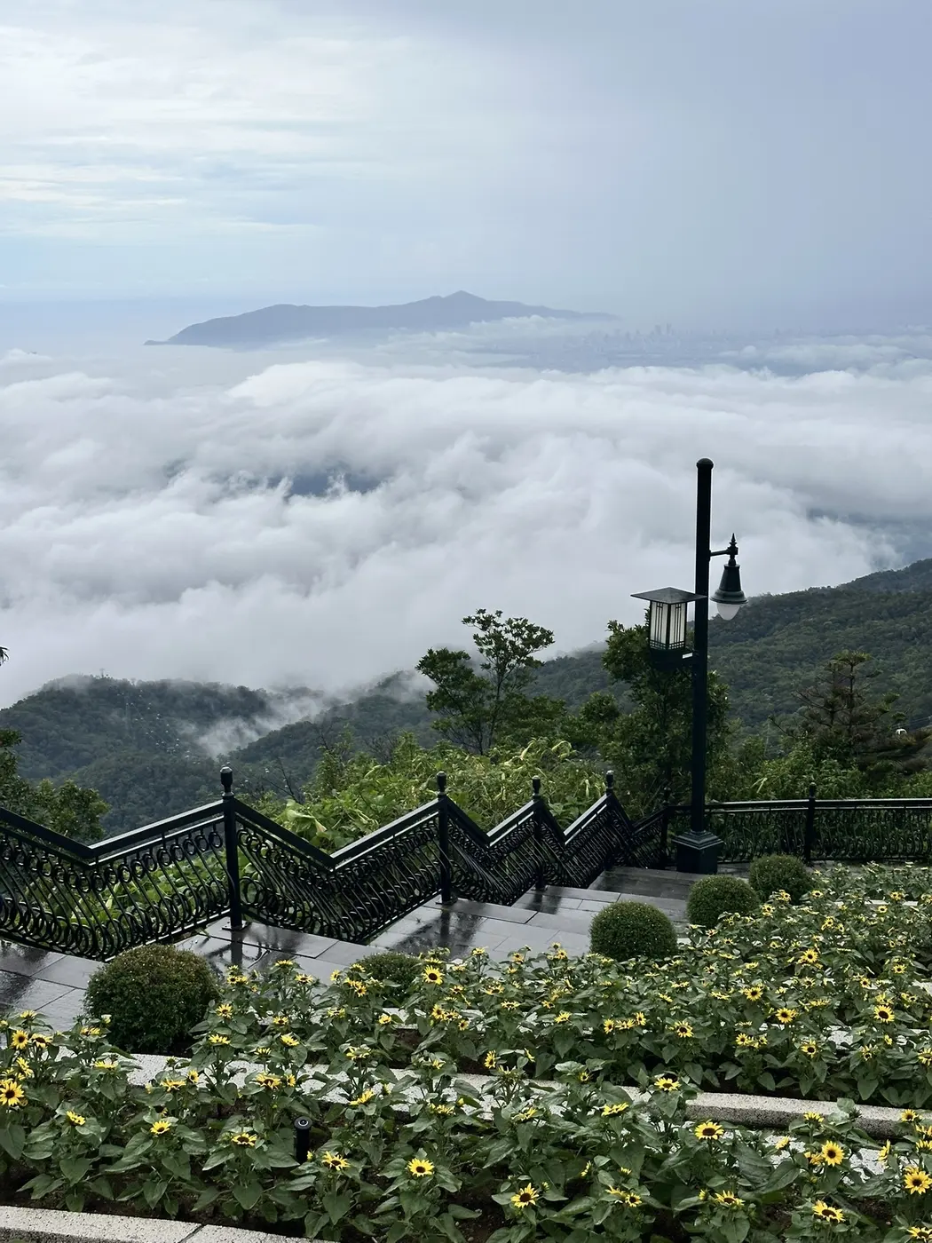 Stone staircase and sunflowers at a Ba Na Hills viewpoint above the clouds