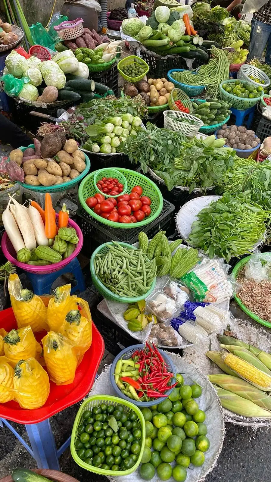 Vegetables and fruit piled high on a Vietnamese market stall