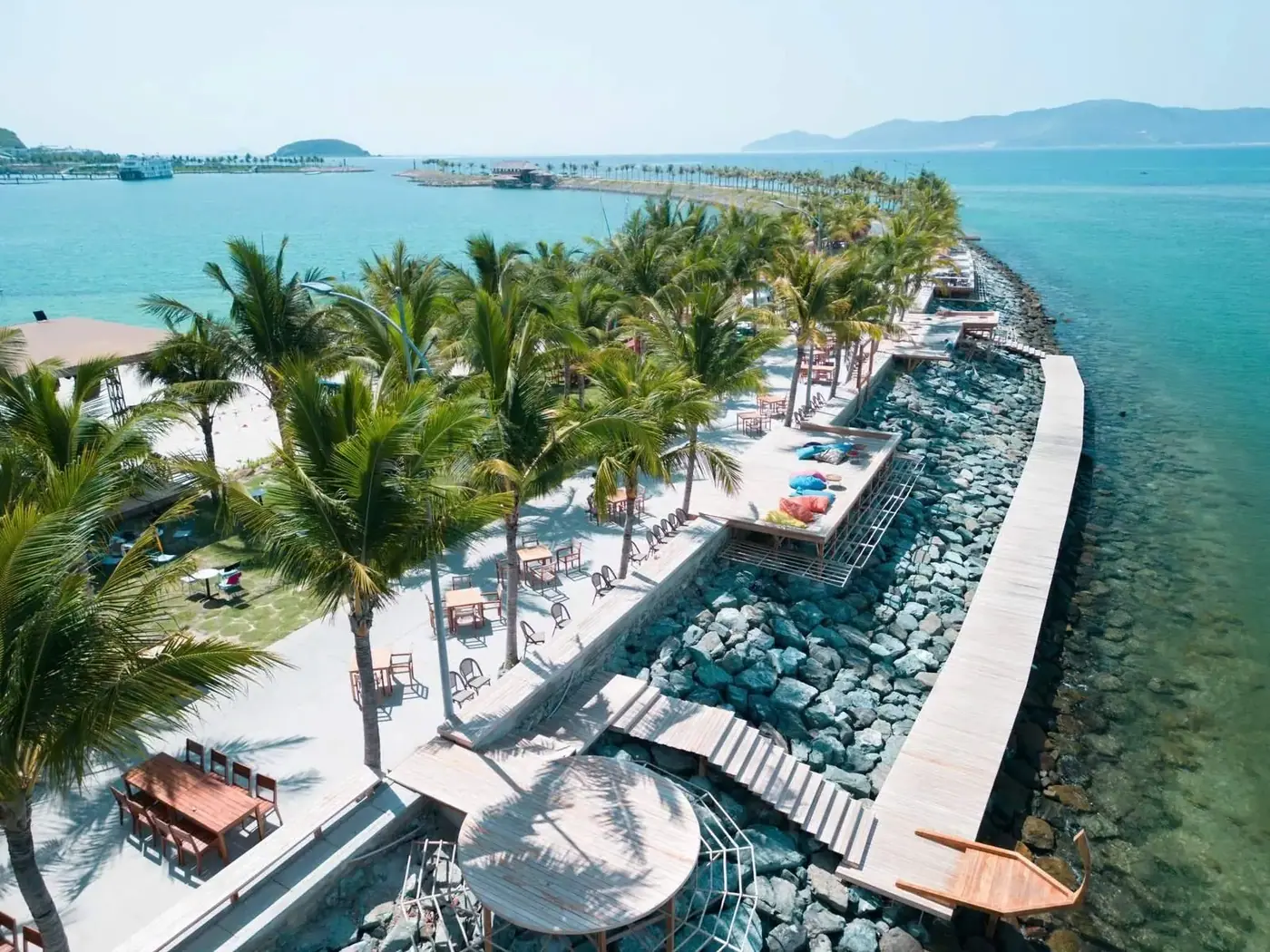 Aerial view of a palm-lined beachfront resort walkway in Nha Trang, Vietnam