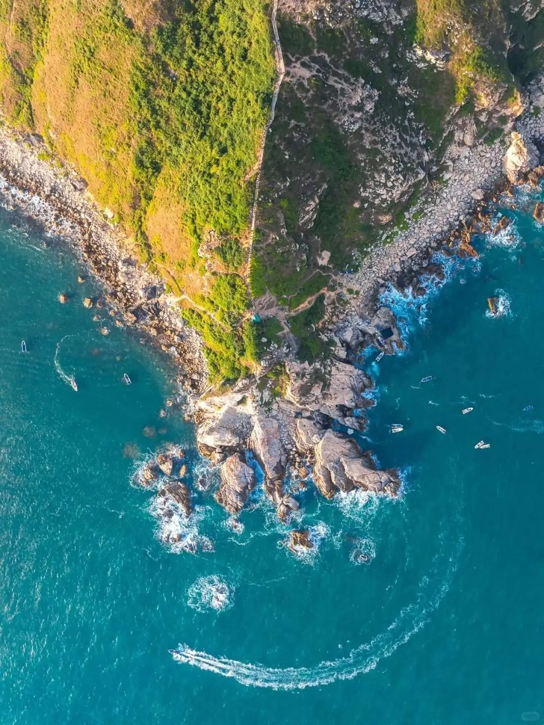 Aerial view of a rocky coastal headland and turquoise water along Vietnam’s central coast