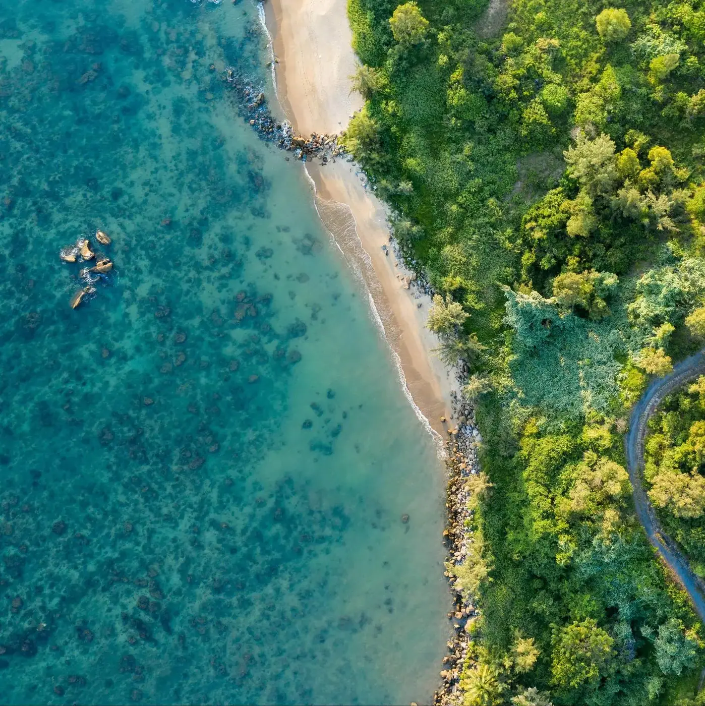 Aerial view of clear turquoise water and sandy beach on Vietnam central coast
