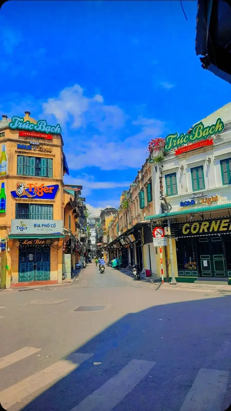Vietnamese old quarter street with Tiger and Truc Bach beer signs