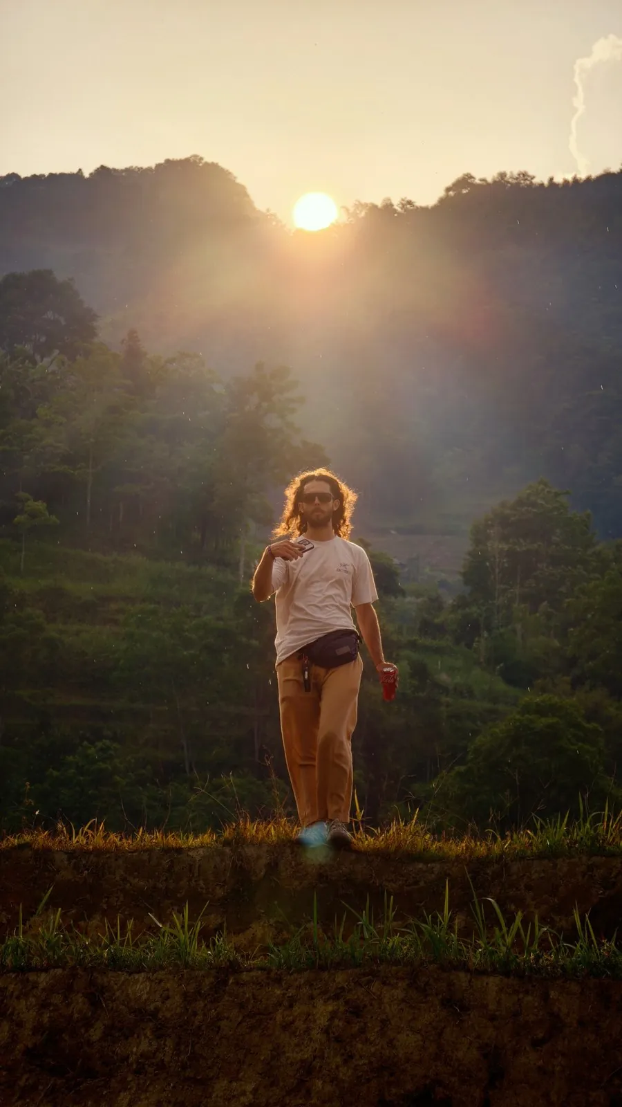 Traveler on a ridge at sunset in the Vietnamese mountains