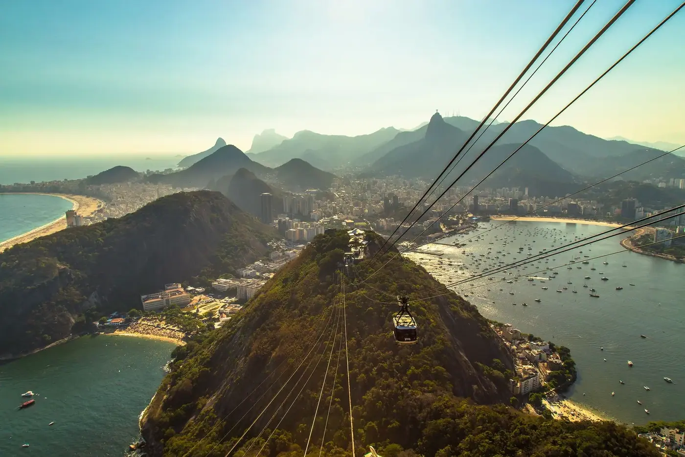 Cable car crossing over hills toward the coastline