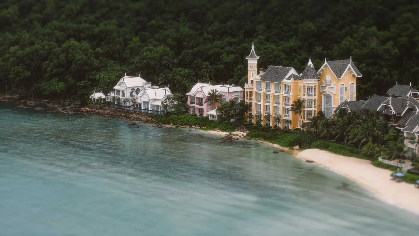 Aerial view of beachfront hotel buildings on a forested Phu Quoc shore