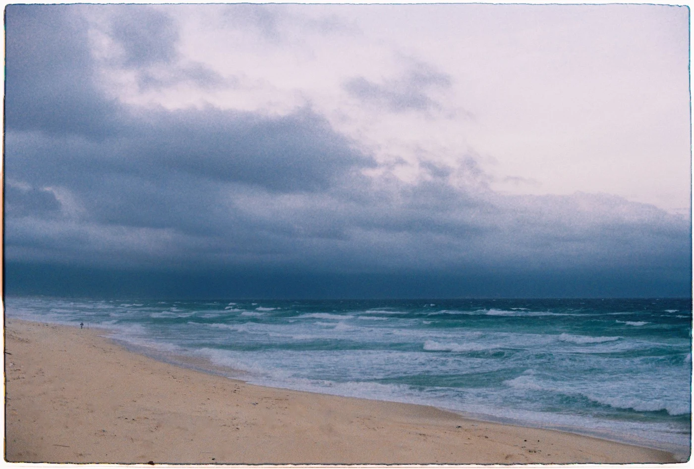 Stormy sea and dark clouds over a sandy beach in Vietnam