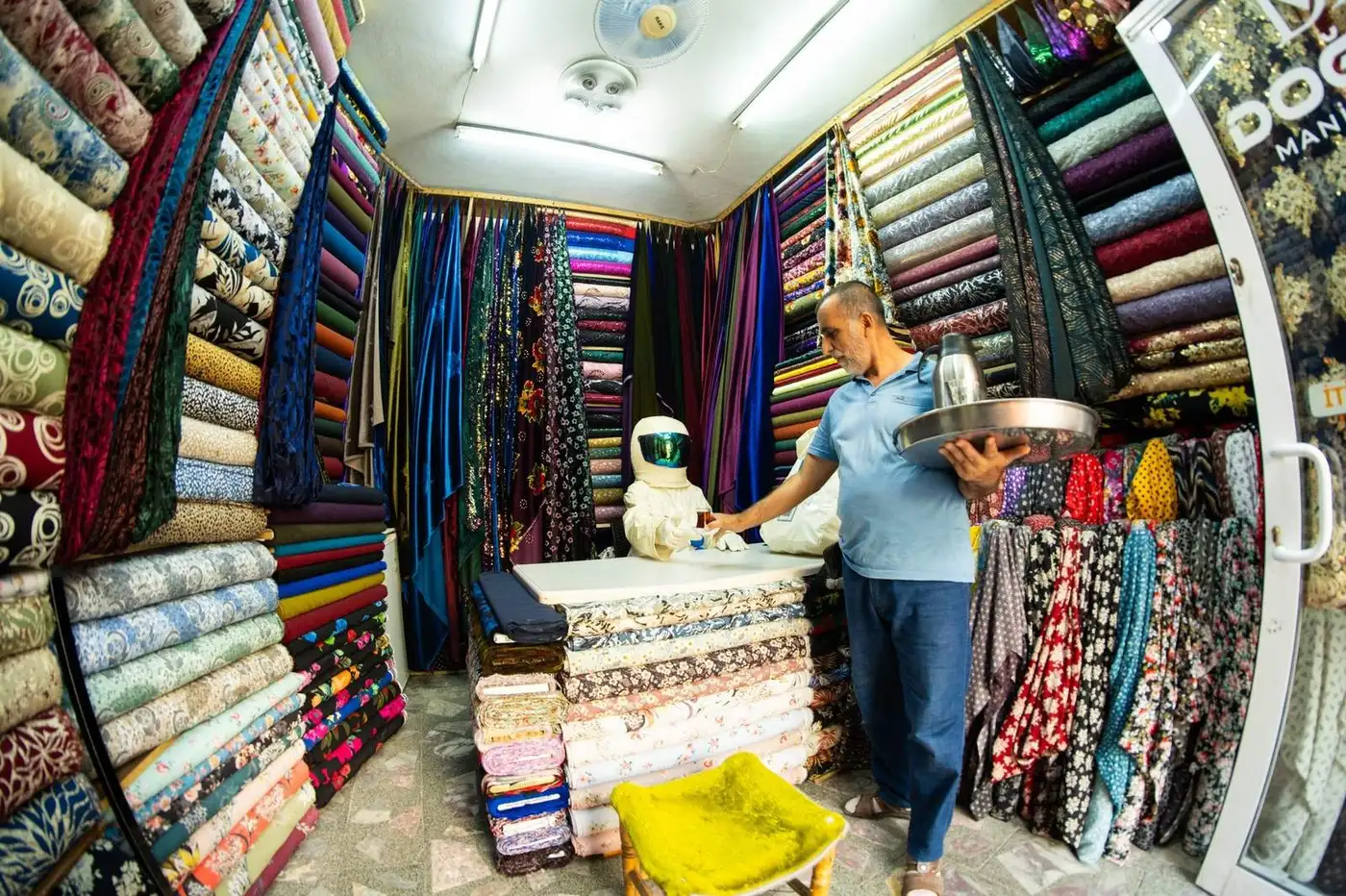 Tailor shop in Hoi An with rolls of colorful silk fabric