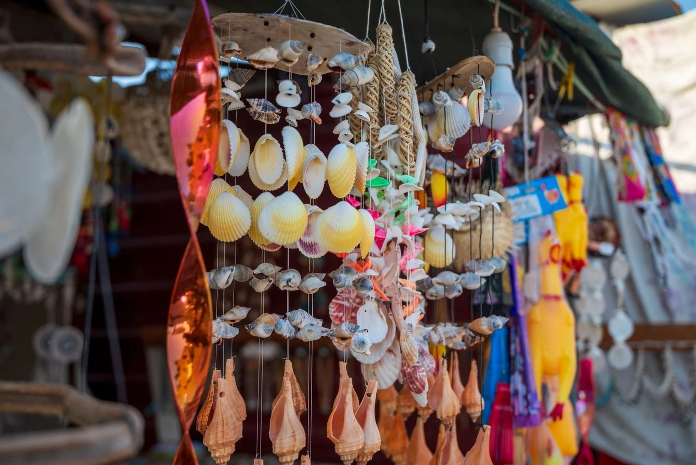 Seashell souvenir wind chimes hanging at a market stall