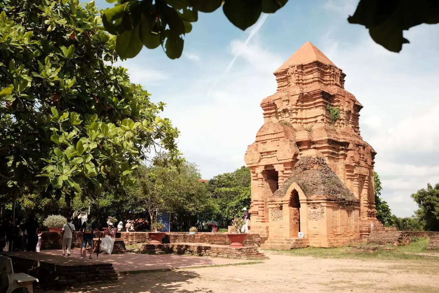Ancient red brick Cham tower on a hill near Phan Thiet with visitors