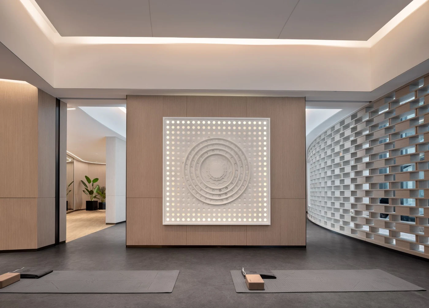 Spacious yoga studio with wooden floor and wall art